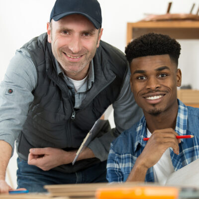 trainer and apprentice are smiling at the camera